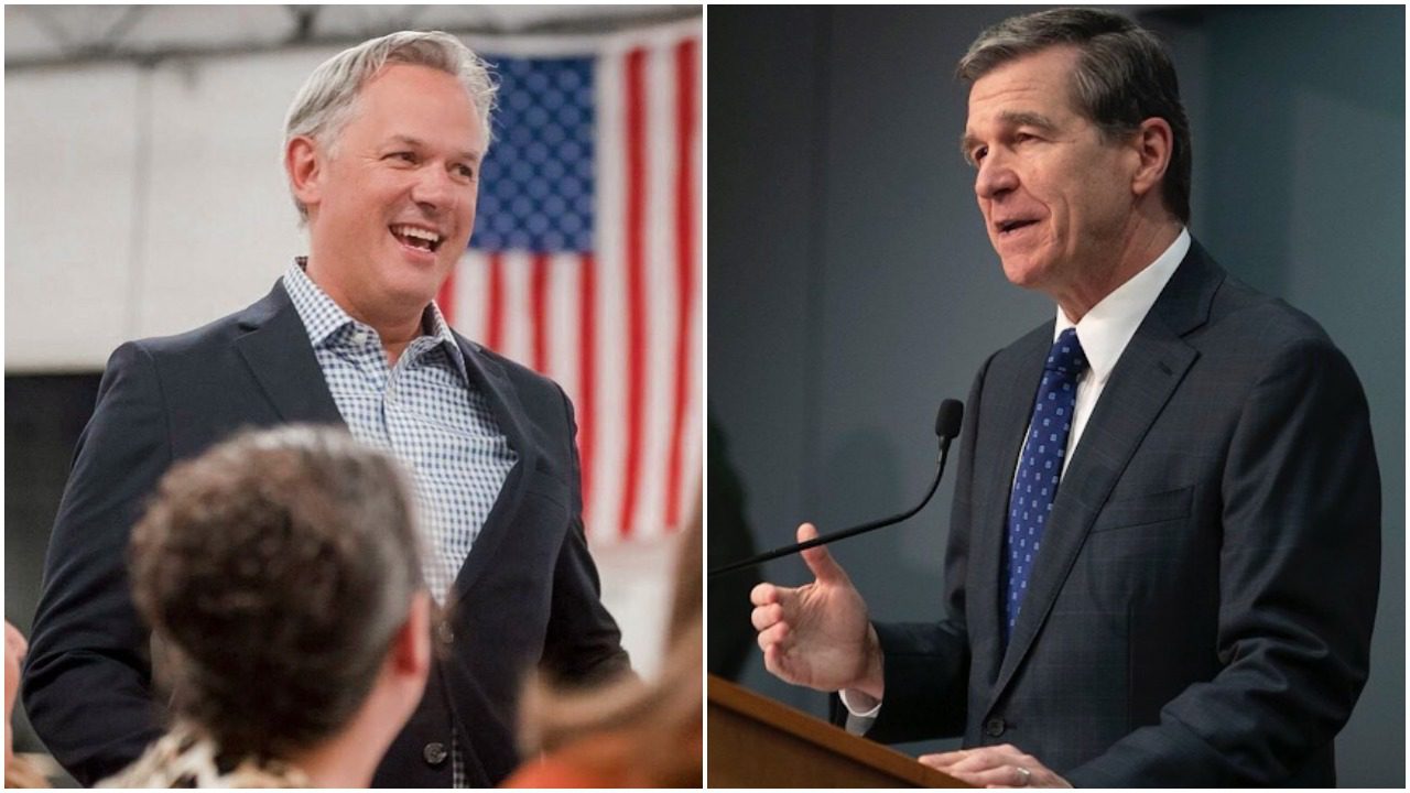 Forest, to the left, stands at a rally speaking. An American flag is behind him and he wears a suit. Cooper, to the right, wears a suit with a blue tie as he speaks in front of a grey background at a podium.