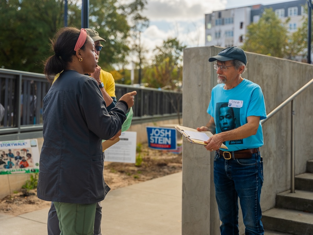 A volunteer greeets a voter at the Durham Public Library. 