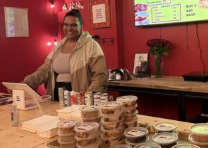 Ashleigh Ratchford, the owner of Ashleigh Bakes Daily, behind the counter at her shop.