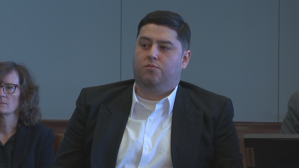 Miguel Salguero-Olivares in court in a white shirt and a black jacket.
