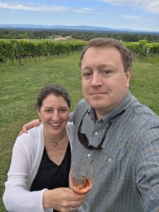 a man and woman holding a glass of wine