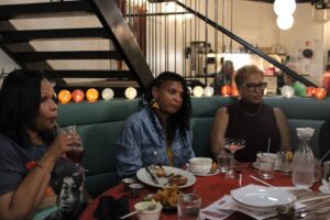 Three women sit around a table at Lula & Sadie's restaurant.